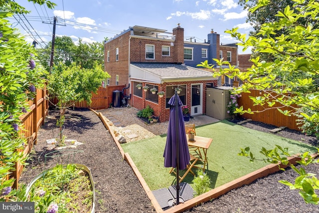 6526 N Capitol St NW, Washington, DC 20012 - back of property featuring brick siding, a shingled roof, a fenced backyard, and a chimney