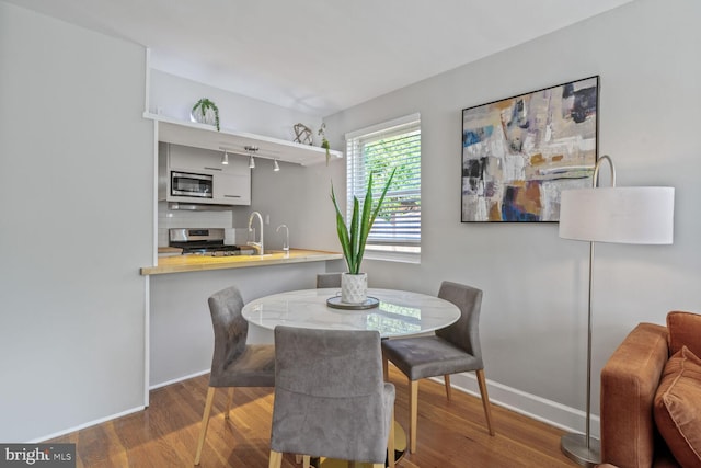 6526 N Capitol St NW, Washington, DC 20012 - dining space with baseboards and wood finished floors