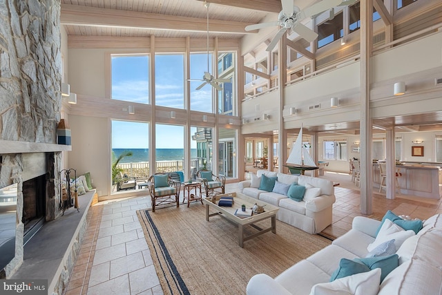 40113 Owens Ct, Fenwick Island, DE 19944 - living room featuring a water view, a high ceiling, a ceiling fan, and a healthy amount of sunlight
