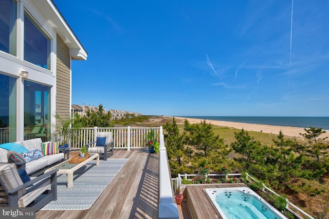 40113 Owens Ct, Fenwick Island, DE 19944 - wooden terrace with an outdoor hot tub, a water view, outdoor lounge area, and a view of the beach
