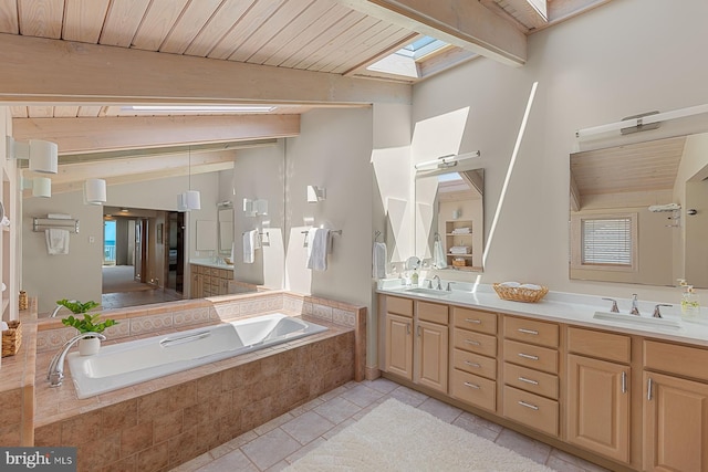 40113 Owens Ct, Fenwick Island, DE 19944 - full bathroom featuring a sink, tile patterned floors, double vanity, lofted ceiling with skylight, and a garden tub