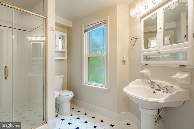 bathroom featuring toilet, a shower stall, and healthy amount of natural light