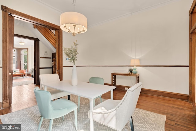 2133 Bolton St, Baltimore, MD 21217 - dining area featuring wood finished floors, crown molding, and baseboards