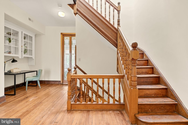 2133 Bolton St, Baltimore, MD 21217 - stairs featuring hardwood / wood-style flooring and baseboards