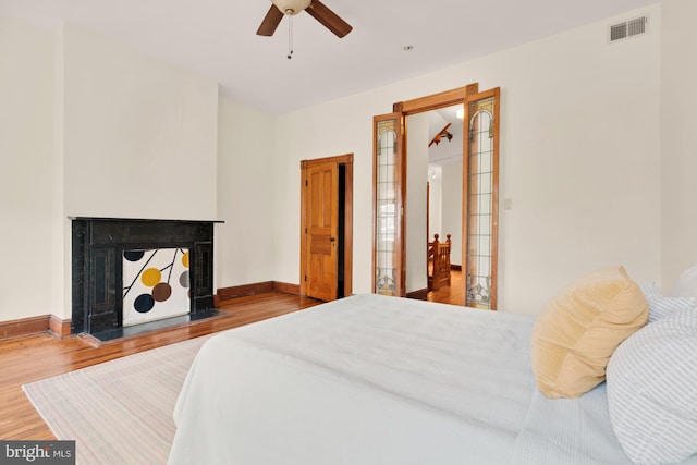 2133 Bolton St, Baltimore, MD 21217 - bedroom featuring wood finished floors, baseboards, a fireplace, and ceiling fan