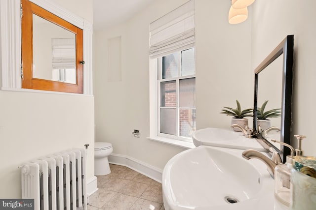 2133 Bolton St, Baltimore, MD 21217 - bathroom featuring radiator, a sink, baseboards, tile patterned floors, and toilet