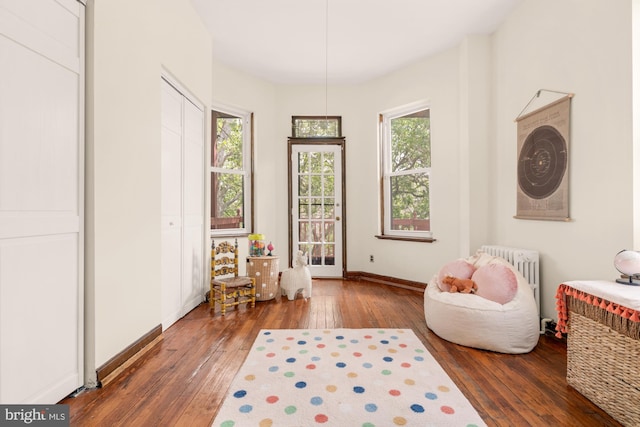 2133 Bolton St, Baltimore, MD 21217 - sitting room featuring radiator heating unit, wood-type flooring, and baseboards