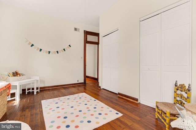 2133 Bolton St, Baltimore, MD 21217 - bedroom featuring wood-type flooring, baseboards, and multiple closets