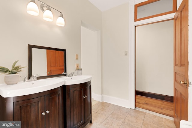 2133 Bolton St, Baltimore, MD 21217 - bathroom featuring tile patterned floors, vanity, and baseboards