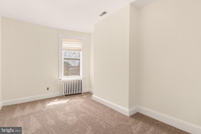 2133 Bolton St, Baltimore, MD 21217 - carpeted spare room featuring radiator and baseboards