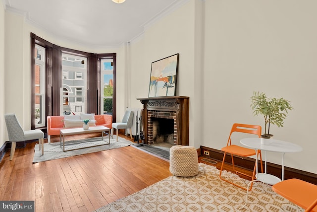 2133 Bolton St, Baltimore, MD 21217 - living area featuring hardwood / wood-style flooring, a fireplace, ornamental molding, and baseboards