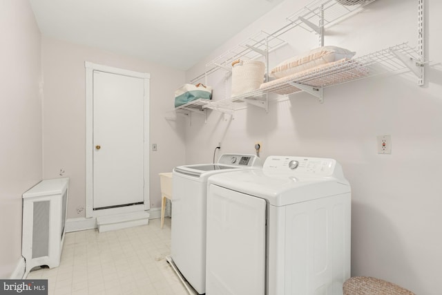 2133 Bolton St, Baltimore, MD 21217 - clothes washing area featuring washing machine and clothes dryer, baseboards, and light floors
