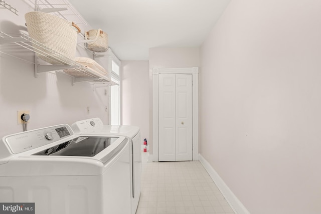 2133 Bolton St, Baltimore, MD 21217 - clothes washing area with washing machine and dryer, light flooring, and baseboards