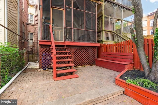 2133 Bolton St, Baltimore, MD 21217 - view of patio / terrace featuring a sunroom, fence, and stairs