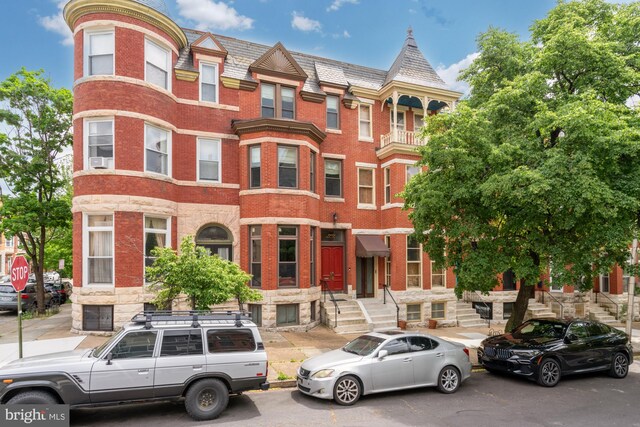 2133 Bolton St, Baltimore, MD 21217 - view of front facade featuring brick siding and a high end roof