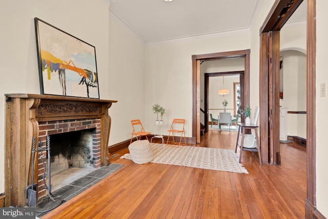 2133 Bolton St, Baltimore, MD 21217 - living area with arched walkways, hardwood / wood-style flooring, ornamental molding, a fireplace, and baseboards