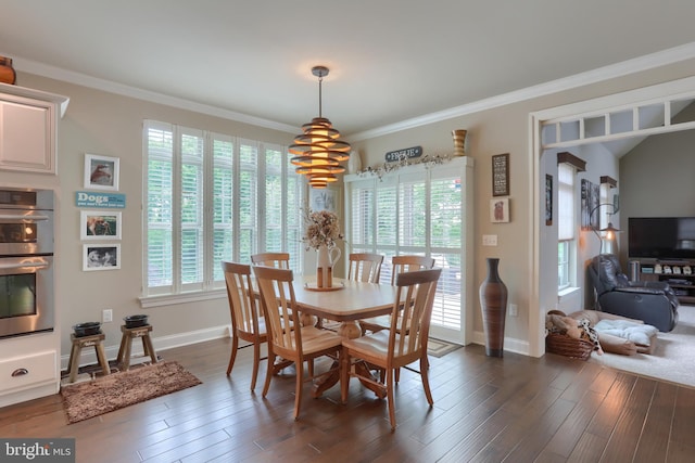 dining area featuring dark wood-type flooring, baseboards, and ornamental molding