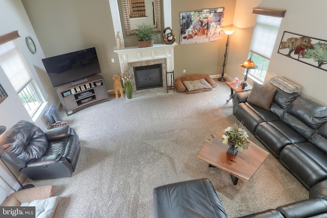 carpeted living room featuring a tiled fireplace