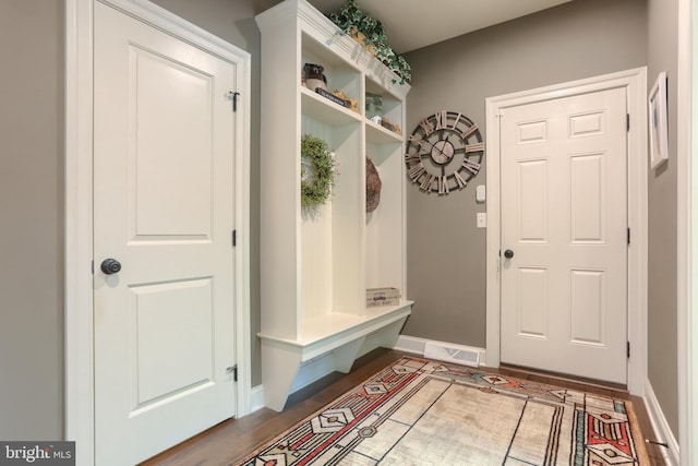 mudroom with wood finished floors and baseboards