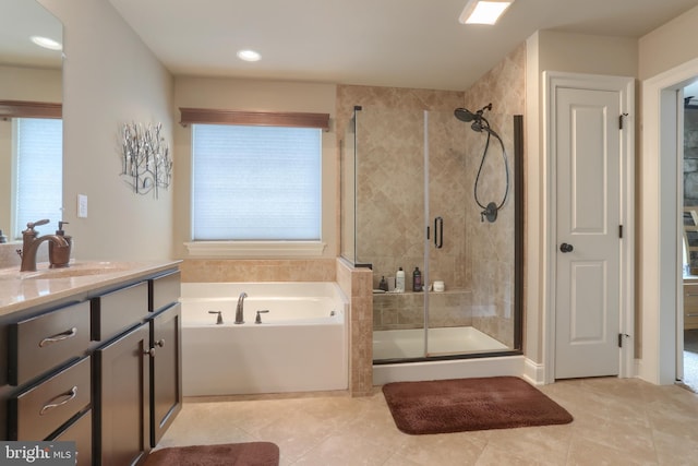 full bath featuring a bath, vanity, tile patterned flooring, and a shower stall