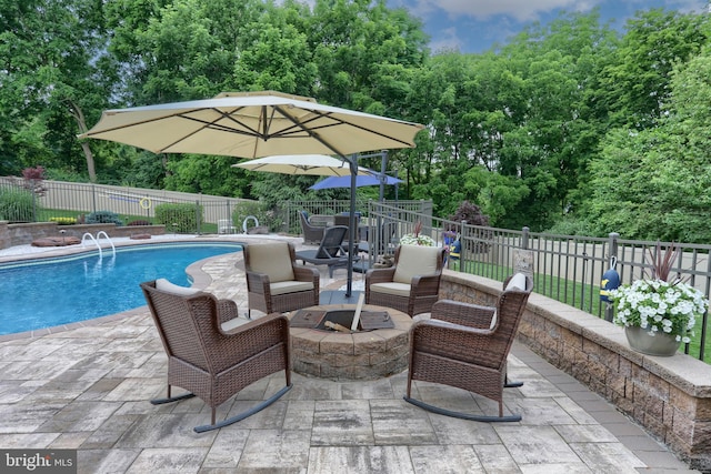 view of patio / terrace with a fenced backyard, an outdoor fire pit, and a fenced in pool
