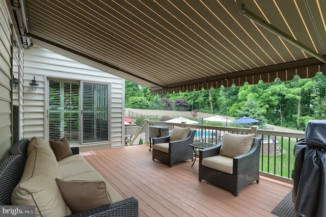 deck with an outdoor living space and grilling area