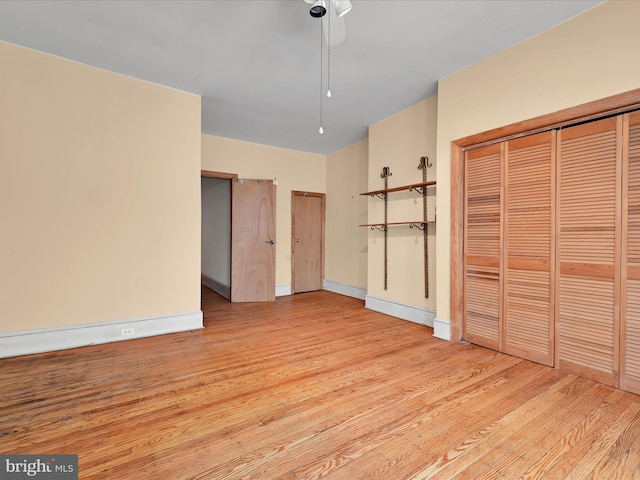 unfurnished bedroom with light wood-style floors, baseboards, and a ceiling fan