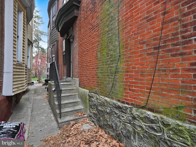 view of side of home with brick siding