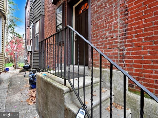 view of exterior entry with brick siding