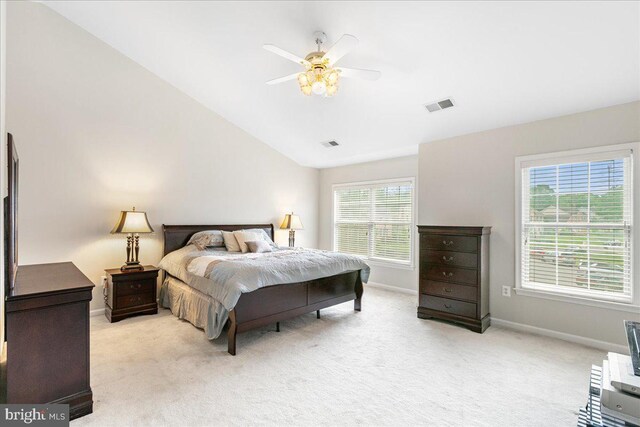 bedroom with lofted ceiling, light carpet, and baseboards