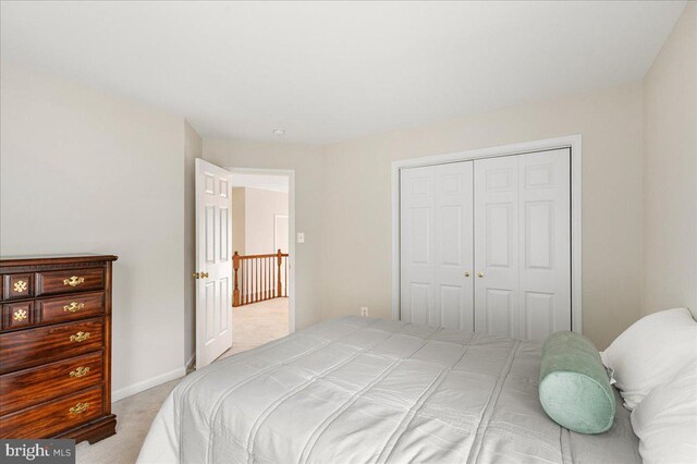 carpeted bedroom featuring a closet