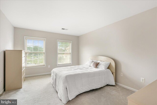 carpeted bedroom featuring baseboards