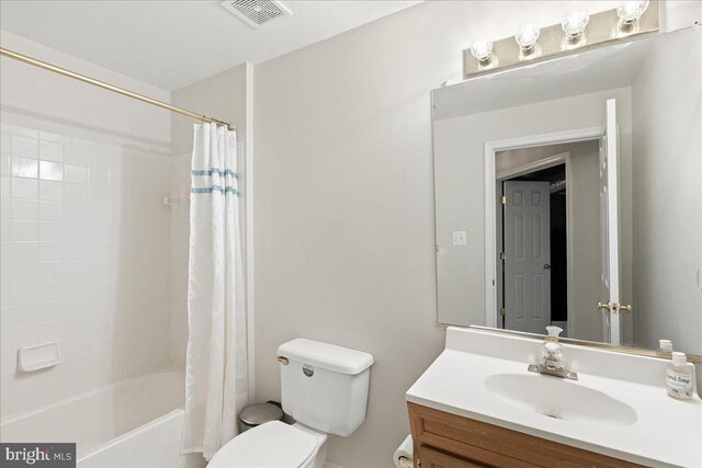 bathroom featuring toilet, vanity, and shower / bathtub combination with curtain