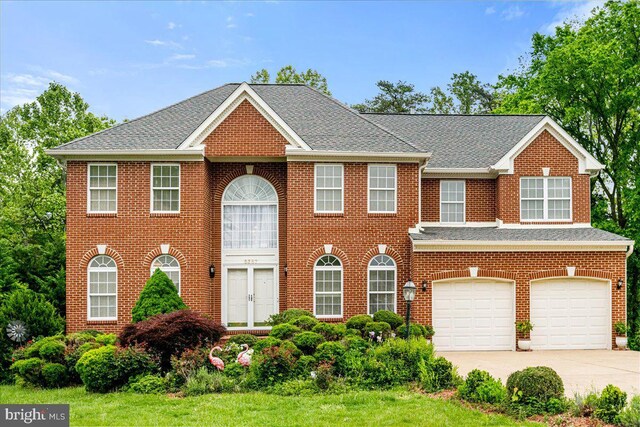 view of front of home featuring concrete driveway, brick siding, an attached garage, and a shingled roof