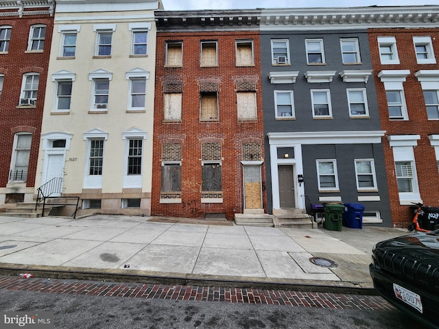 view of property featuring entry steps and brick siding