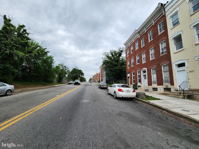 view of street with street lighting, curbs, and sidewalks