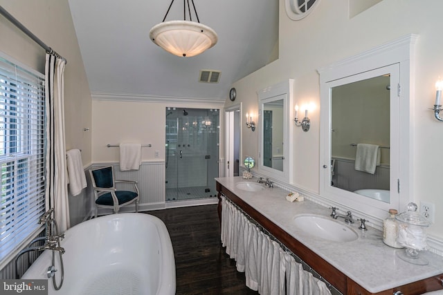 full bathroom featuring a sink, vaulted ceiling, a shower stall, and wood finished floors
