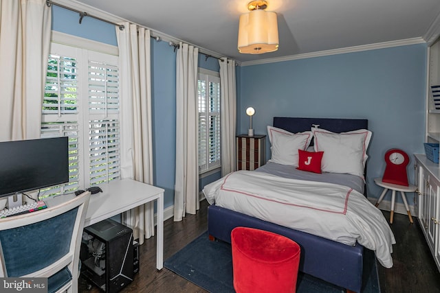 bedroom with baseboards, crown molding, and wood finished floors