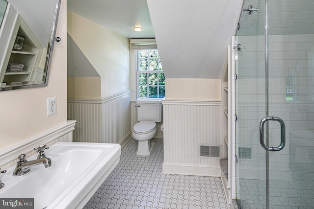 full bathroom featuring wainscoting, visible vents, a stall shower, and a sink