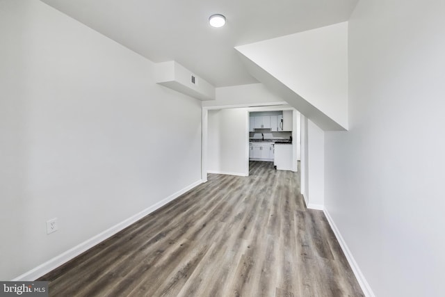 1 Maple Ave, Baltimore, MD 21206 - bonus room featuring dark wood-style floors and baseboards