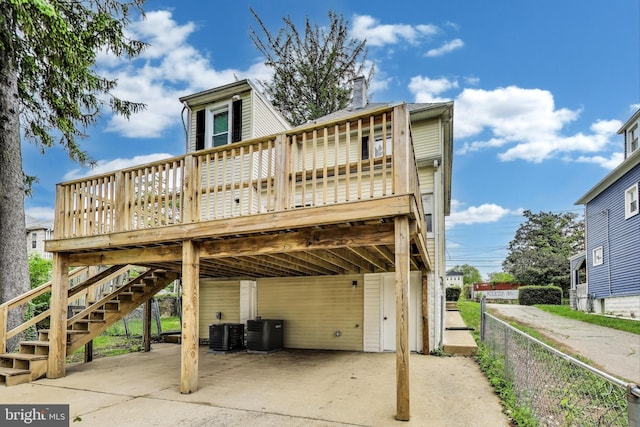 1 Maple Ave, Baltimore, MD 21206 - back of house with a carport, a deck, central AC unit, and stairs