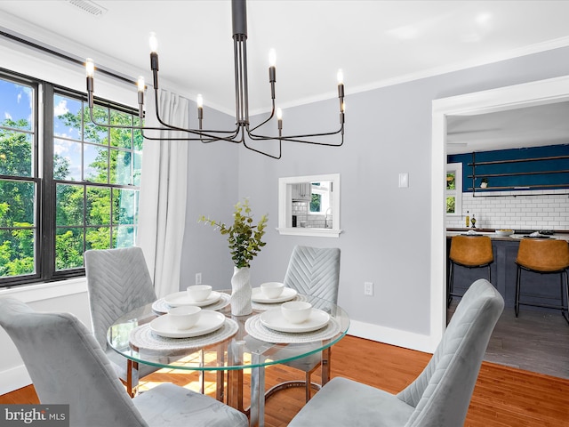 1990 Kate Dr, Port Republic, MD 20676 - dining area featuring a chandelier, baseboards, wood finished floors, and crown molding
