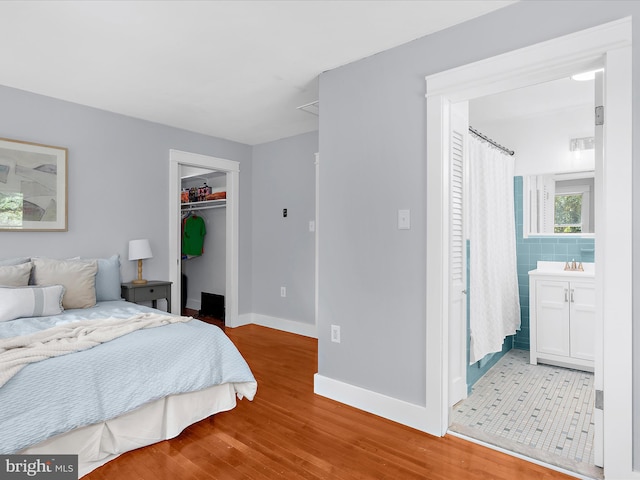 1990 Kate Dr, Port Republic, MD 20676 - bedroom with wood finished floors, baseboards, a spacious closet, and a closet