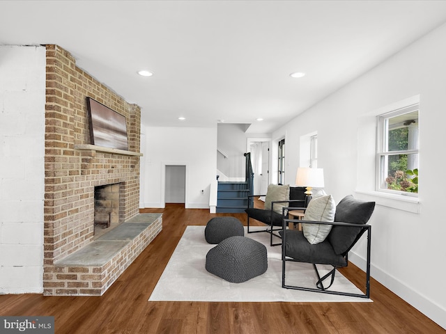 1990 Kate Dr, Port Republic, MD 20676 - living room featuring baseboards, wood finished floors, stairs, a fireplace, and recessed lighting