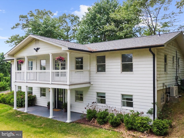 1990 Kate Dr, Port Republic, MD 20676 - back of house featuring a balcony, a patio, a yard, and a shingled roof