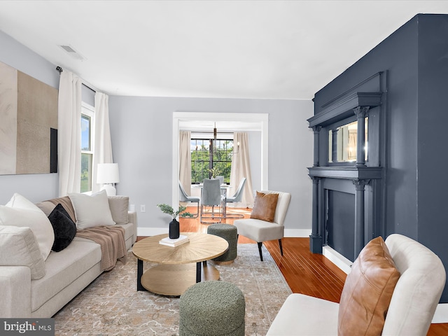 1990 Kate Dr, Port Republic, MD 20676 - living area with wood finished floors, baseboards, and a chandelier