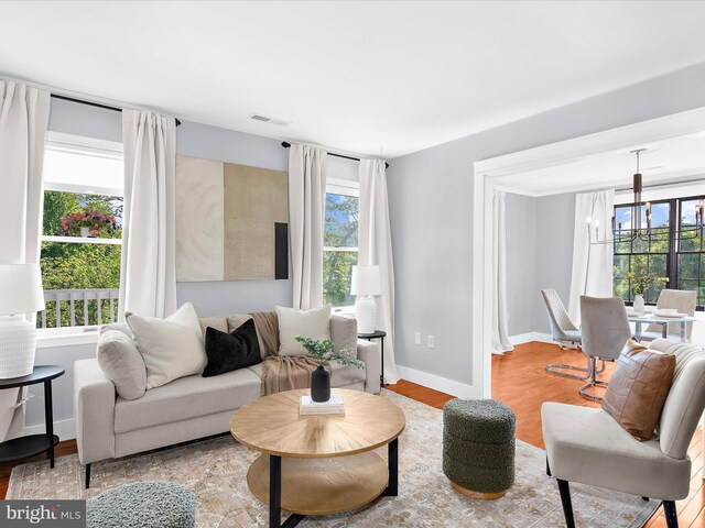 1990 Kate Dr, Port Republic, MD 20676 - living room featuring a chandelier, plenty of natural light, and wood finished floors