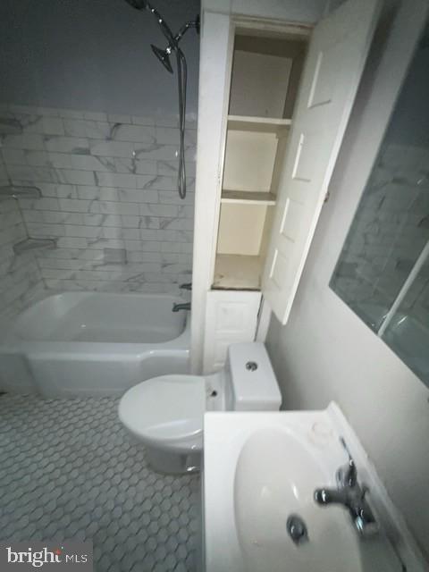 full bathroom with a sink,  shower combination, and toilet