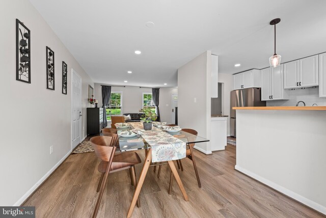 9518 Center St, Vienna, VA 22181 - dining area with light wood-type flooring, baseboards, and recessed lighting