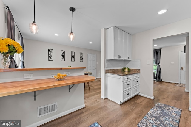 9518 Center St, Vienna, VA 22181 - kitchen featuring wooden counters, white cabinetry, decorative backsplash, wood finished floors, and recessed lighting
